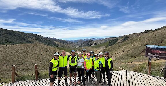Group photo and stunning lookout on Argentina to Chile bike tour. toAT