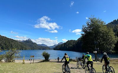 Rolling along open lakeshores on Argentina to Chile bike tour. toAT
