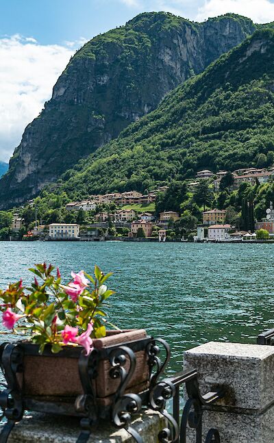 Quiet lakeside villages below steep mountain slopes. Unsplash@ChristopherPolitano