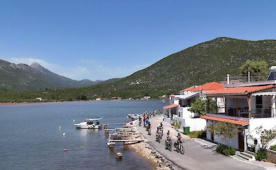 Cyclists arriving at a small harbor village on the Mani coast. toABB