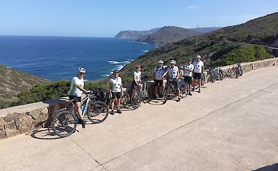 Cyclists riding above the coastline. toBTS