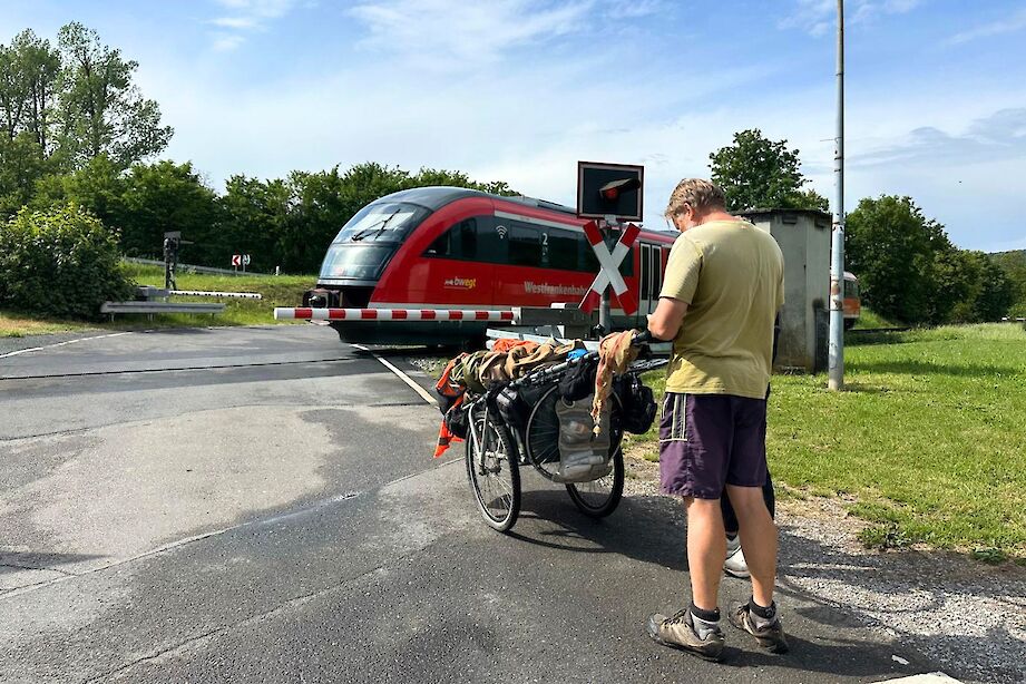 Karl Bushby waiting at a railway crossing en route to Frankfurt, Germany. CC:Rosalind Perrett