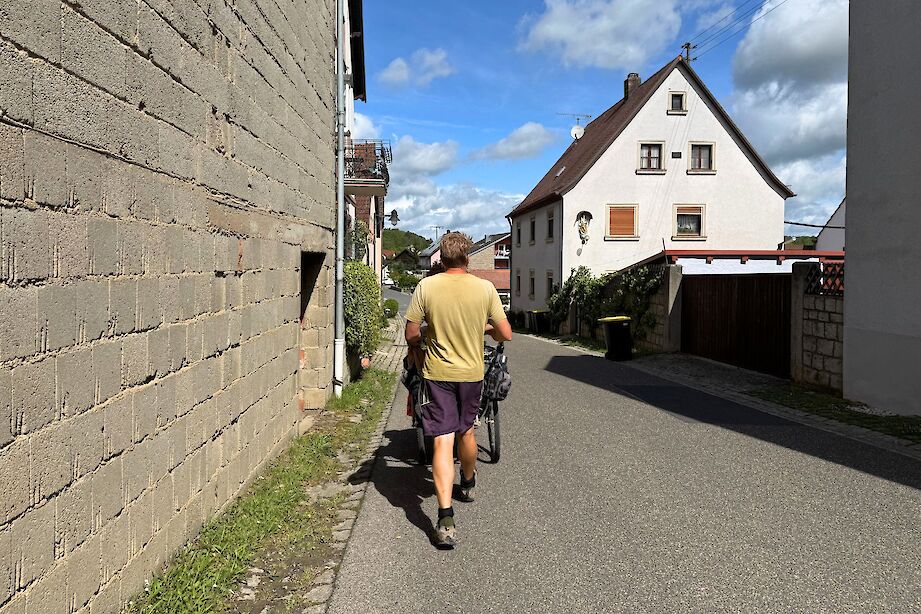 Karl Bushby walking through a rural German town. CC:Rosalind Perrett