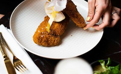 Chef preparing Austrian schnitzel. Unsplash@Jakob Trost