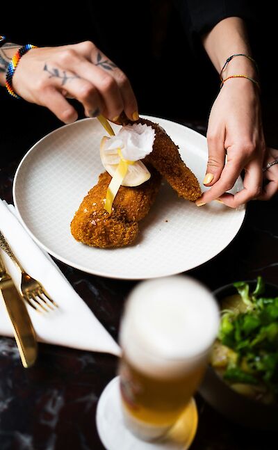Chef preparing Austrian schnitzel. Unsplash@Jakob Trost