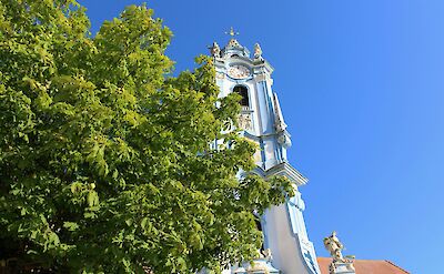 The blue and white bell tower of the D&uuml;rnstein Abbey, Austria. Unsplash@Daniela Turcanu