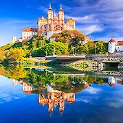 Luxury Danube Cruise & Cycle - Passau to Vienna - Melk Abbey, Austria. Stift Melk reflected in the water of Danube River, scenic Wachau Valley.  Photo Astock