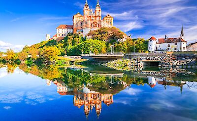 Melk Abbey, Austria. Stift Melk reflected in the water of Danube River, scenic Wachau Valley.  Photo Astock