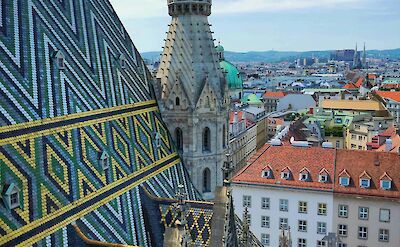 Intricate patterned tile roof and stone spire of St. Stephen's Cathedral, Vienna, Austria. Unsplash@Victor Malyushev