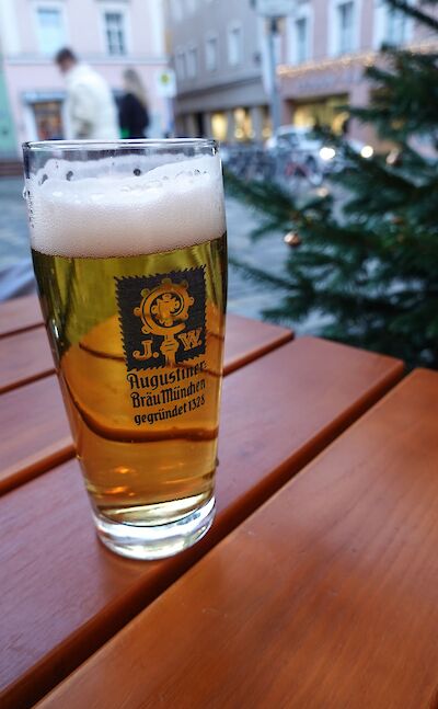 A glass of traditional German lager at an outdoor café. pexels:pexels:MagdaEhlers