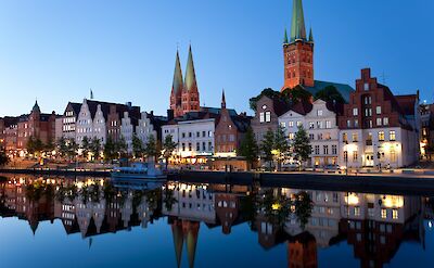 L&uuml;beck's historic skyline reflected on the Trave River. toBBT