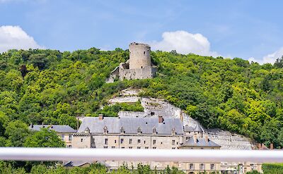 A historic stone castle ruin overlooking a large chateau at the base of the cliffs in Les Andelys, France. toTN