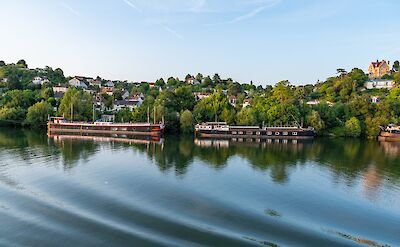 Large river barges anchored on the Seine river in Les Andelys, France. toTN