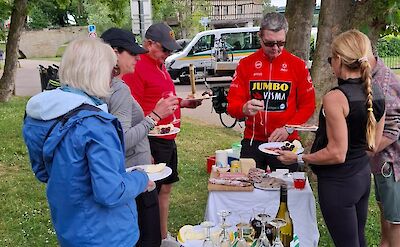 An outdoor buffet with snacks, fresh fruit, and drinks. toTN