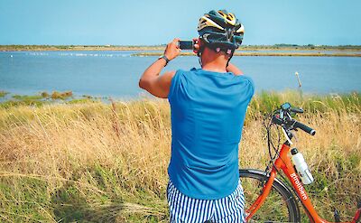 A cyclist pauses along the coastal route. toGL
