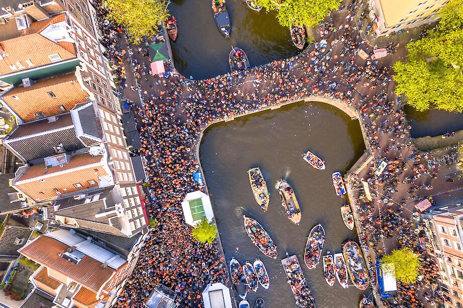 Drone shot of Amsterdam's canals on King's Day. iStock@CreativeNature_nl