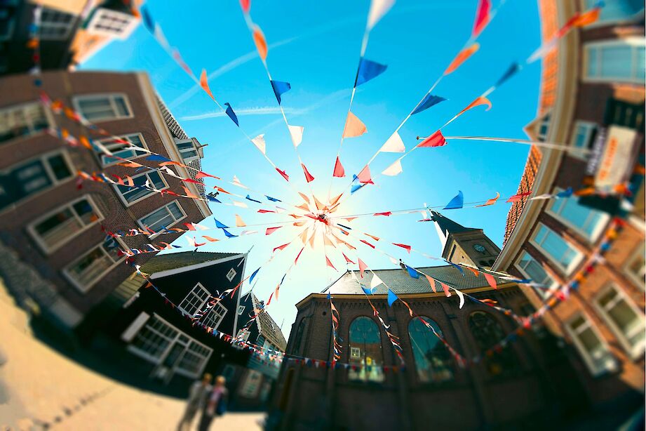 Flags in the street for King's Day, Netherlands. iStock@Lindrik
