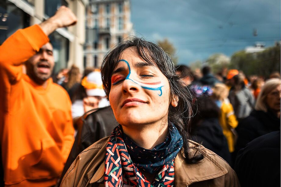 Soaking up the atmosphere during King's Day in the Netherlands. Unsplash@Peyman Shojaei