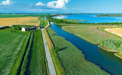 Scenic cycling paths between canals and coastal wetlands. cc:to