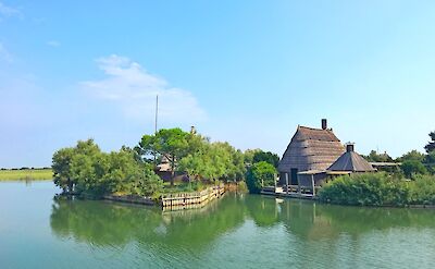 Traditional fishing huts along the lagoon waterways. cc:to