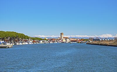Fishing boats in the harbor of Marano Lagunare, with the snow-capped Alps in the distance. cc:to