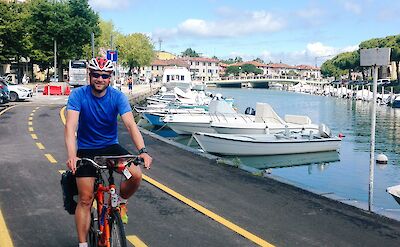 Cyclists riding along a waterfront bike path in northeastern Italy. cc:to