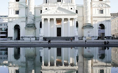 Karlskirche reflected in the water, Vienna, Austria. Unsplash@Laurenz Kleinheider