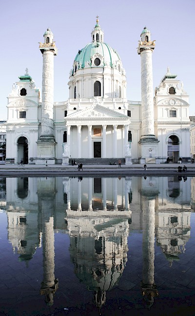 Karlskirche reflected in the water, Vienna, Austria. Unsplash@Laurenz Kleinheider