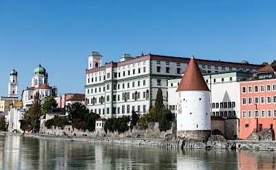 Turreted building on the Passau waterfront, Germany. Unsplash@Wolfgang Weiser