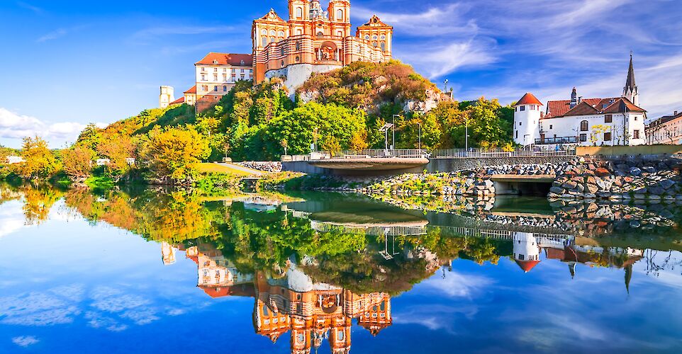 Melk Abbey, Austria. Stift Melk reflected in the water of Danube River, scenic Wachau Valley.  Photo Astock