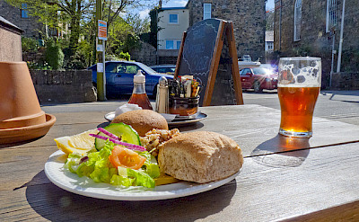 Fresh crab sandwich and some beer in Pembrokeshire. Photo via Flickr:Dave Collier