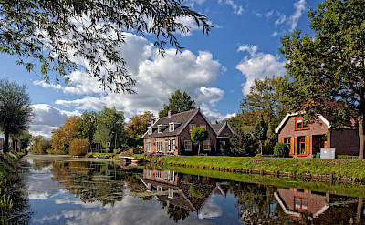Biking along the canals in the Netherlands. ©Hollandfotograaf