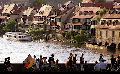 Soccer fans heading home past Bamberg's Little Venice. Flickr:Qole Pejorian