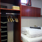 Cabin bed and closet | Clair d’Etoile | Bike & Boat Tour