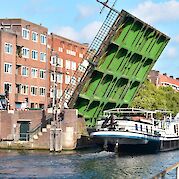 Sailing by the bridge in Amsterdam | Gandalf | Bike & Boat Tour