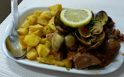 "Carne de Porco à Alentejana," fried pork with clams - a popular dish perfect during an active bike tour! Photo via Flickr:heatheronhertravels