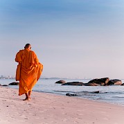 Coastal Thailand - Monk on the beach in Hua Hin, Thailand bike tour. Unsplash@Thomas Oxford