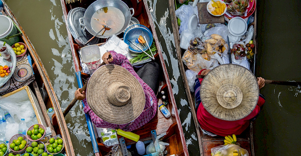 Selling food boatside in Thailand. Photo via Flickr:Georgie Pauwels