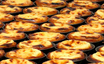 Pastéis de nata - a popular Portuguese egg tart pastry. Visit the famous Pastéis de Belém shop in Lisbon. Photo via Flickr:Kyle Taylor