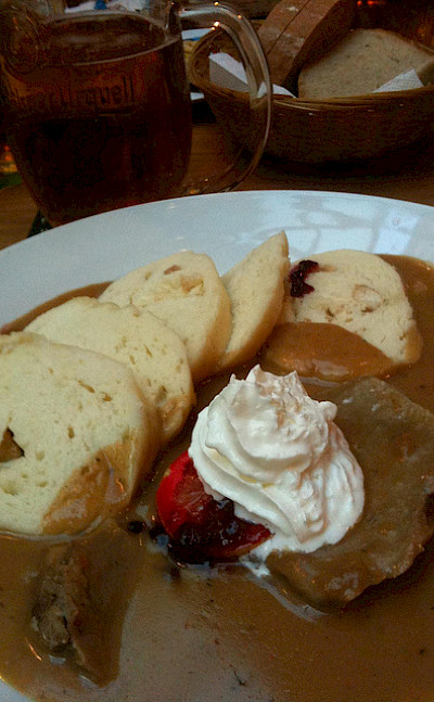 Traditional Czech cuisine with roasted beef served with whipped cream, cranberry sauce and bread dumplings. Photo via Flickr:crystalmartel