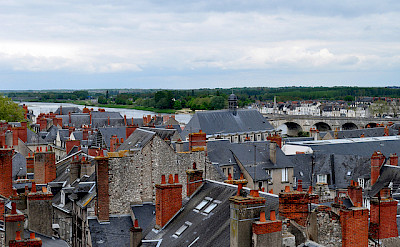 Notice the characteristic gray roofs and red chimneys in Blois, France. Photo via Flickr:Frederique Voisin-Demery