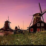 Dutch Delights: Slow Travel, Windmills, and Tulips - Sunset at the Zaanse Schans near Zaandam, the Netherlands. Flickr:Moyan Brenn 52.47286350845113, 4.819470991833409