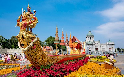 Colorful flowers around a sculpture in Bangkok, Thailand bike tour. Unsplash@Worachat Sodsri