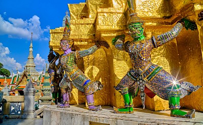 Gleaming gold temple with colorful sculptures in Bangkok, Thailand bike tour. Unsplash@Worachat Sodsri