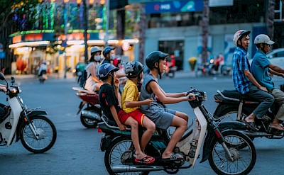 Kids on mopeds in Ho Chi Minh City, Vietnam bike tour. Unsplash@Tron Le