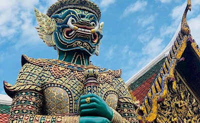 Ornate sculpture outside a temple in Bangkok, Thailand bike tour. Unsplash@Remi Prevost