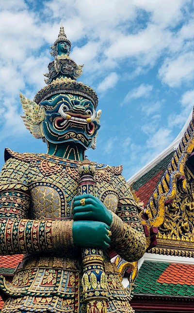Ornate sculpture outside a temple in Bangkok, Thailand bike tour. Unsplash@Remi Prevost