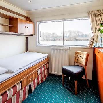 Bordeaux - Upper Deck Twin Cabin with full-size picture window. 2 Twin beds - 1 folds up into the wall during the day - Bordeaux | Bike & Boat Tours