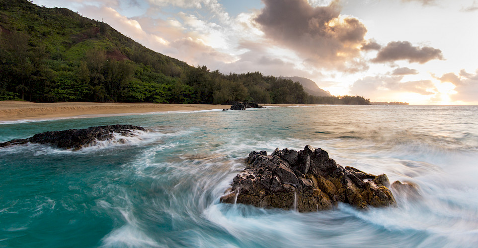 Some rough easterly swells swirling round & round this interesting spot of rocks in the foreground. Lumahai Beach, Kauai, Hawai 