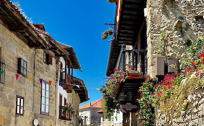 Flowers on buildings in Santillana del Mar, Spain. Unsplash:Rubina Ajdary